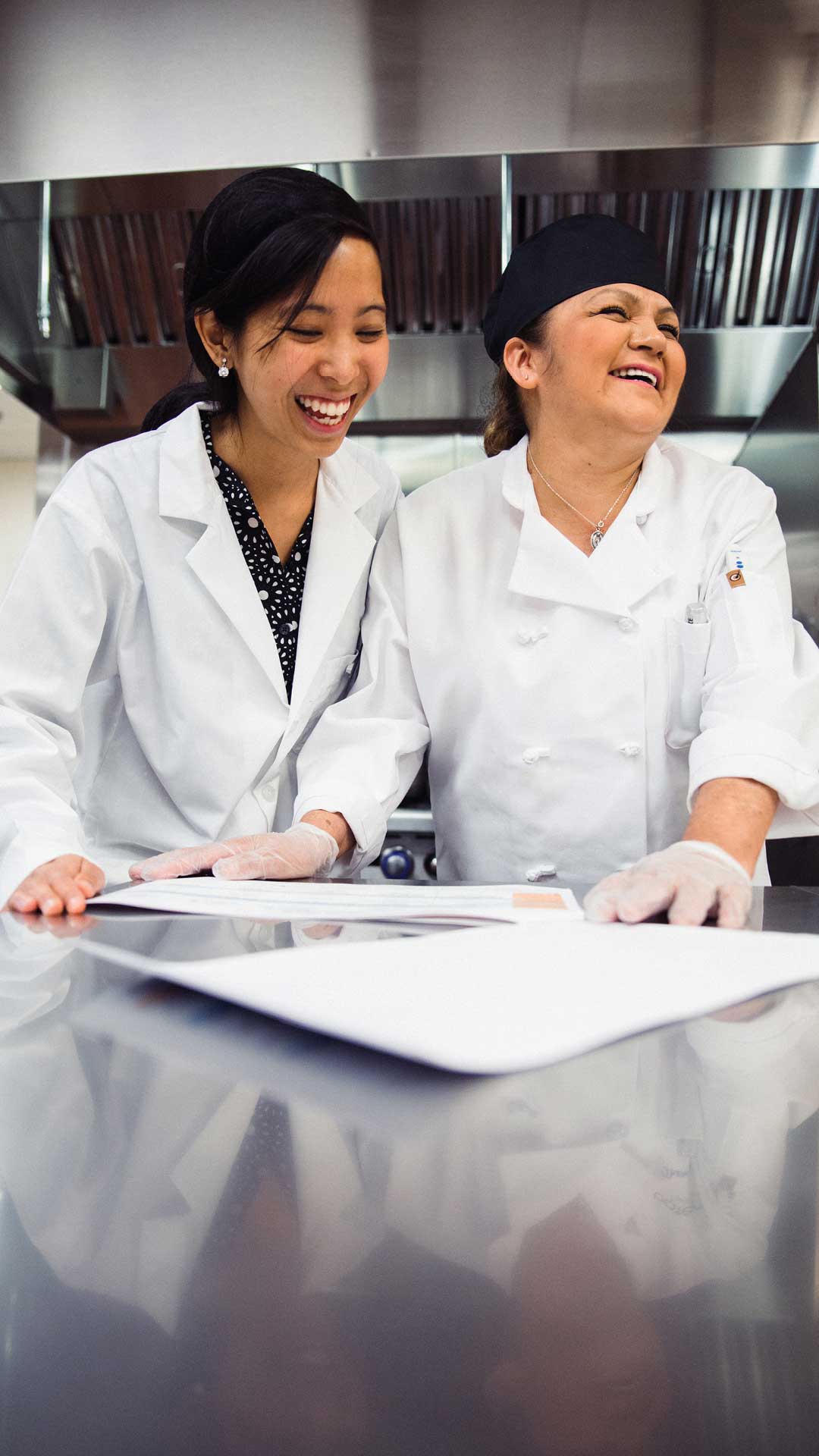 Traditions Meals employees laughing in kitchen