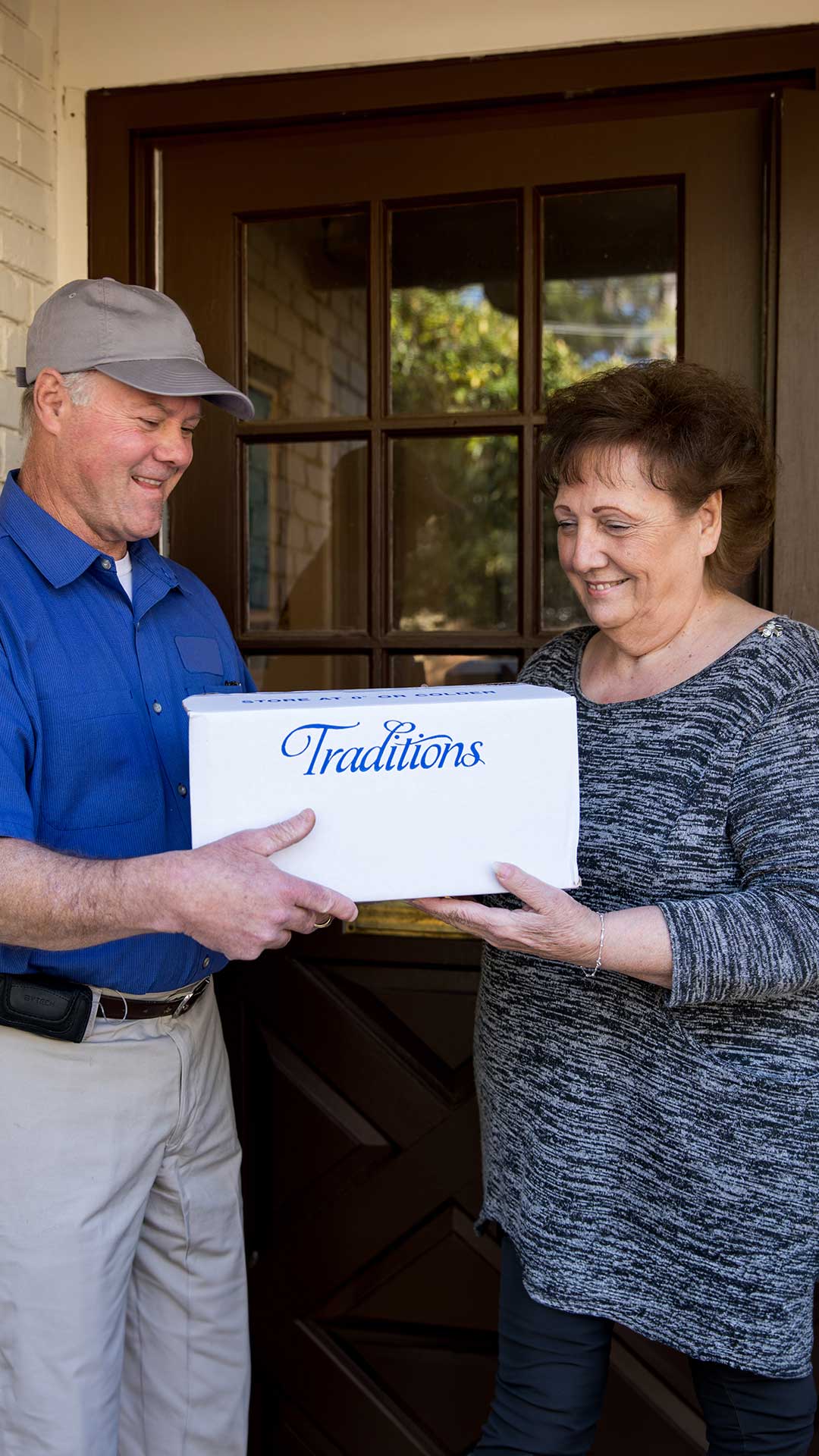 Traditions Meals driver delivering frozen meals to happy customer