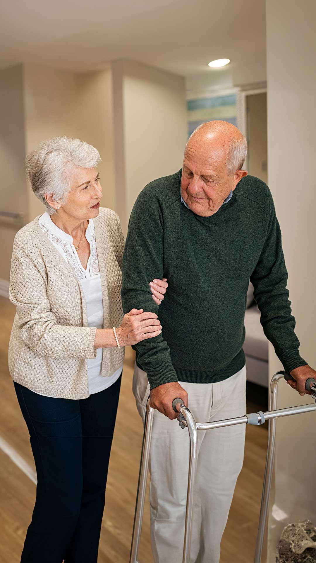 Person with walker and companion assisting while being discharged from hospital